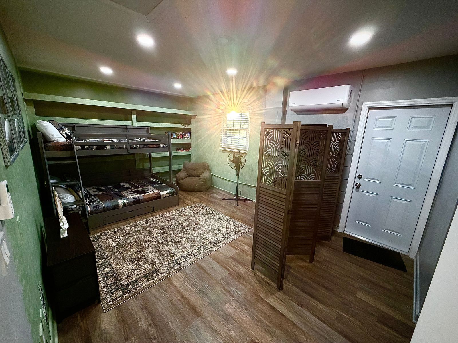 Private-entry suite with full-over-full bunk beds, mini-split AC, and beanbag